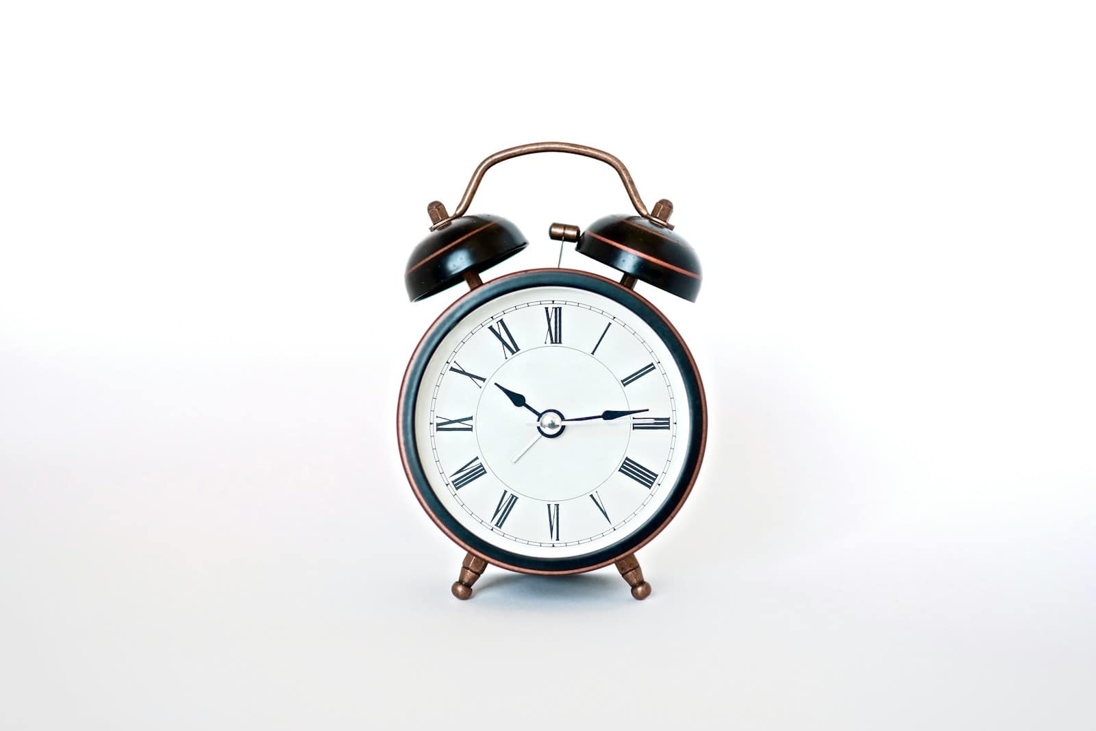 round black and white analog alarm clock